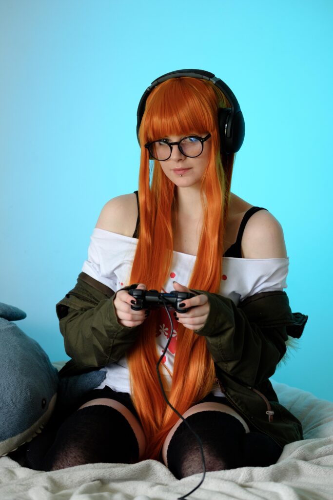 Futaba cosplayer holding playstation two controllers 